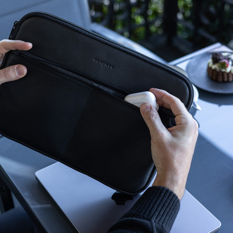 Nordweg black leather laptop sleeve front pocket with earbuds case detail