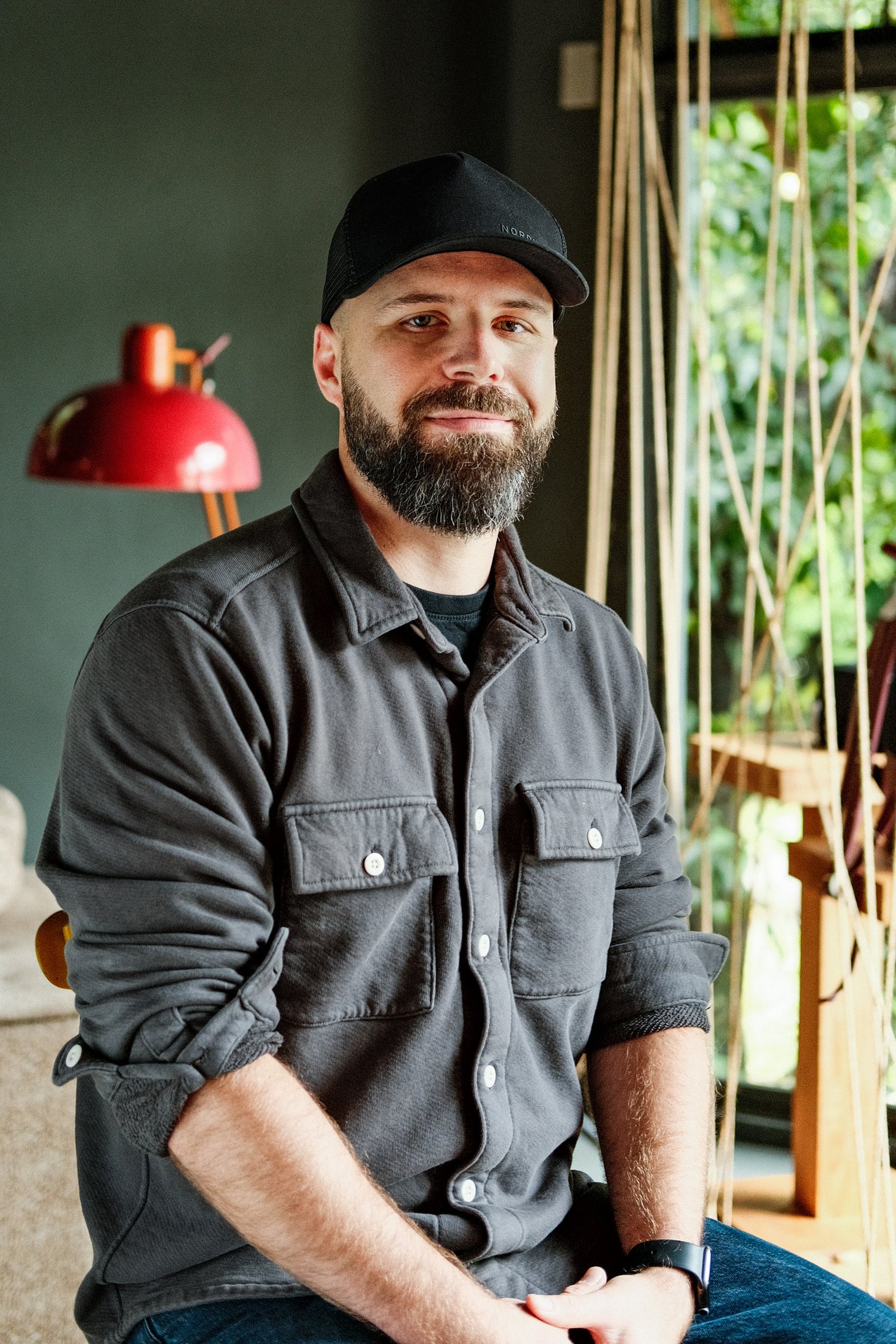Nordweg team member portrait wearing a black Nordweg cap for the brand origin about page