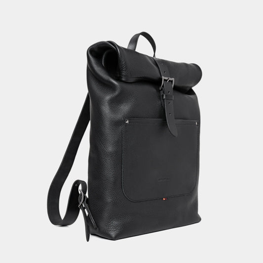 Nordweg Legacy leather backpack in coal, angled front view with roll-top and shoulder strap