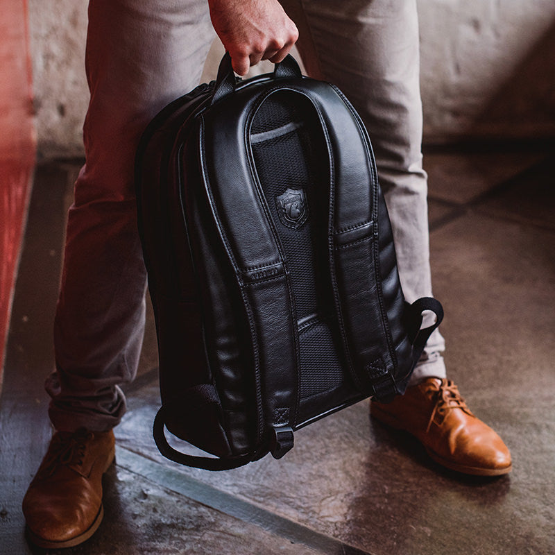 Nordweg black leather backpack and boots close-up in lifestyle photo