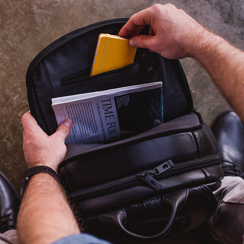 Nordweg black leather cardholder wallet held in hands with a colorful card, lifestyle detail photo