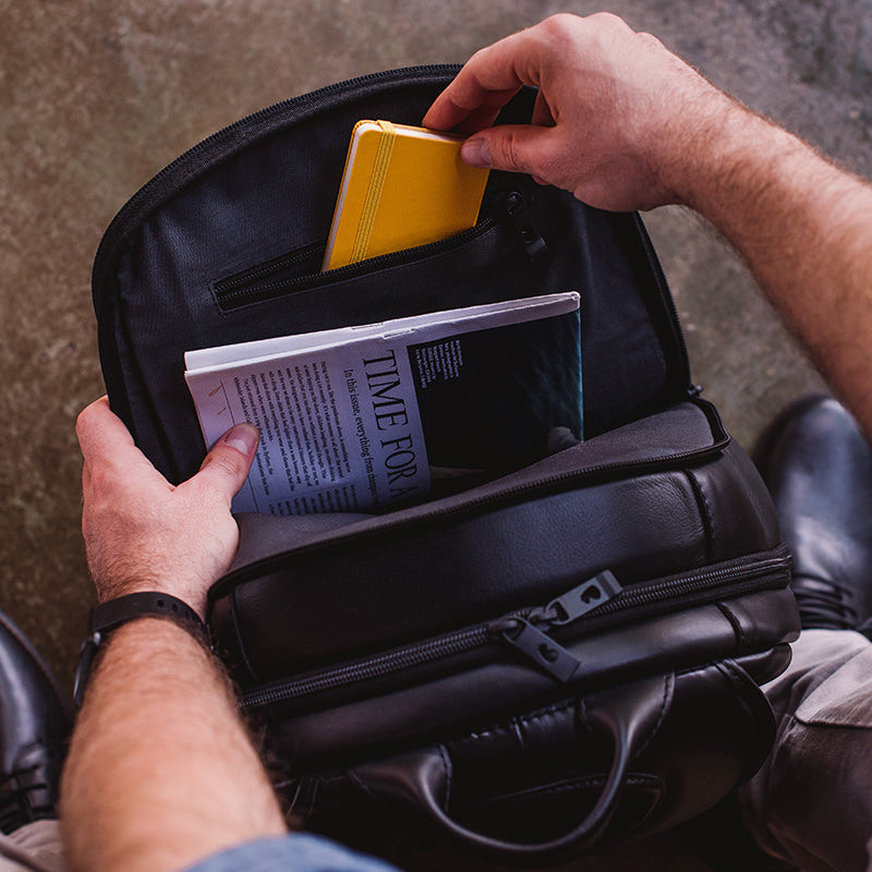 Nordweg black leather cardholder wallet held in hands with a colorful card, lifestyle detail photo