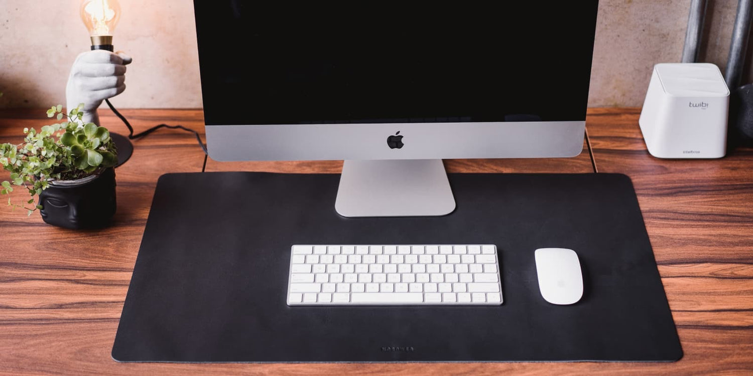 Nordweg black leather desk pad flat lay with laptop and accessories