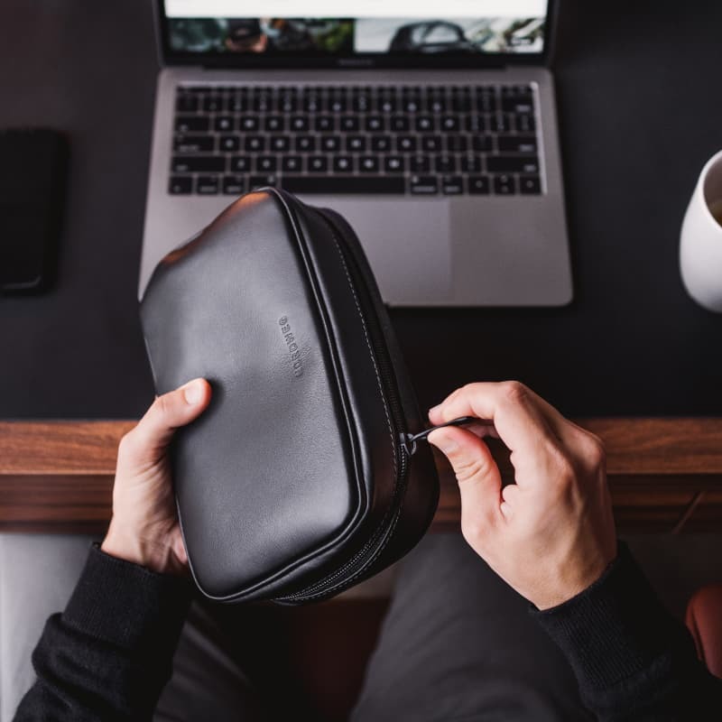 Nordweg black leather desk pad workspace with laptop and hands