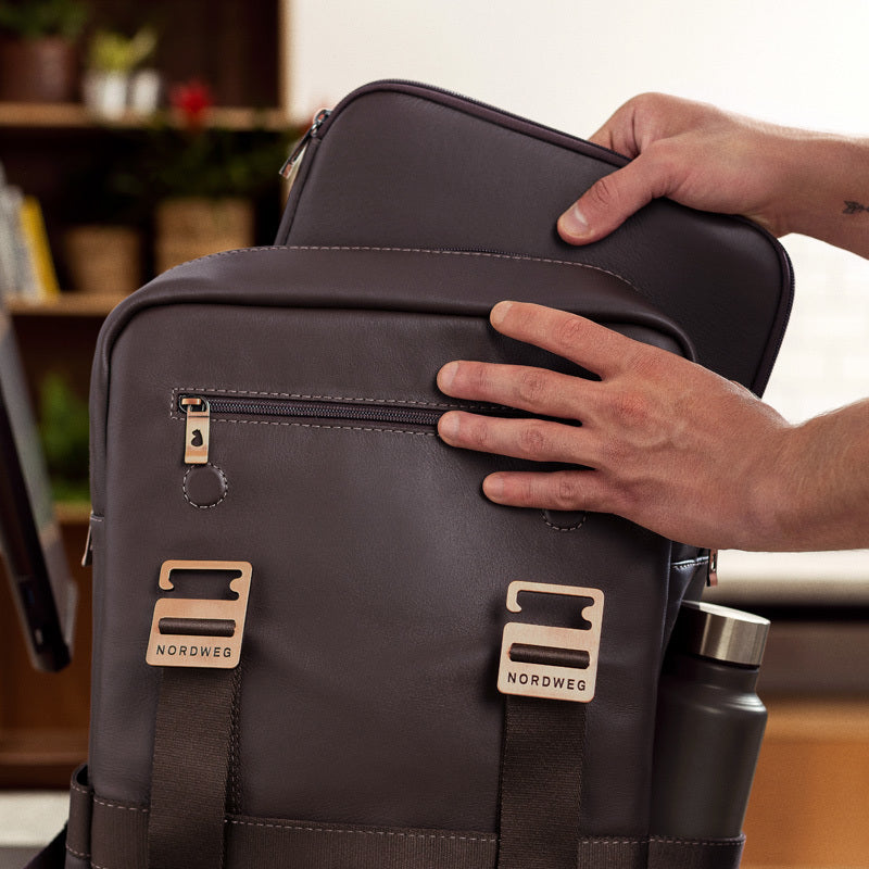 Nordweg brown leather briefcase front flap with metal clasp hardware and hand detail