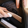 Gray-lined interior of the black Dolomites Travel Backpack with a notebook, mouse, and inner pocket