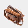 Open caramel Dolomites leather satchel showing packed interior compartments