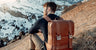 Nordweg Dolomites leather travel backpack in Caramel at a snowy mountain overlook, SKU NW101.CA, GTIN 7898571001044