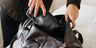 Open coffee Nordweg Dolomites leather weekender being packed with clothing, SKU NW103.IC, GTIN 7898571001068