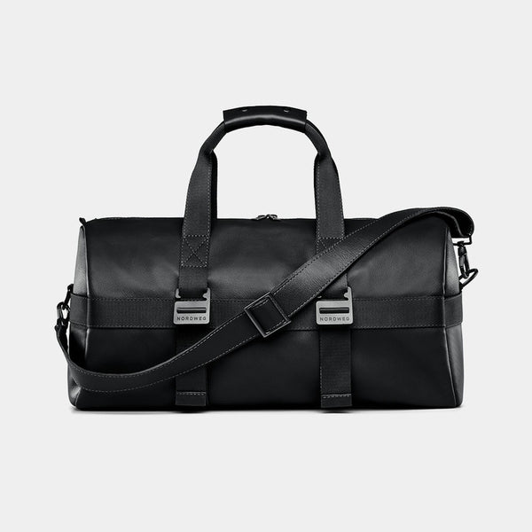 Nordweg Dolomites leather weekender travel bag in black, front view with shoulder strap