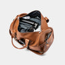 Open caramel Nordweg Dolomites leather weekender bag showing packed interior