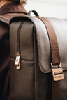 Nordweg Dolomites Coffee leather travel backpack buckle and strap detail while worn