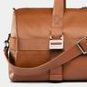 Close-up of the front buckle and shoulder strap on the Nordweg Dolomites Weekender in Caramel.