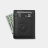 Back view of black Nordweg Flint leather cardholder holding cards and cash