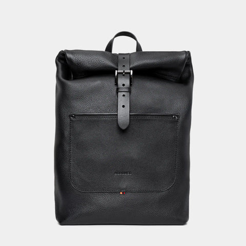 Nordweg Legacy leather backpack in coal, front view with roll-top and metal buckle