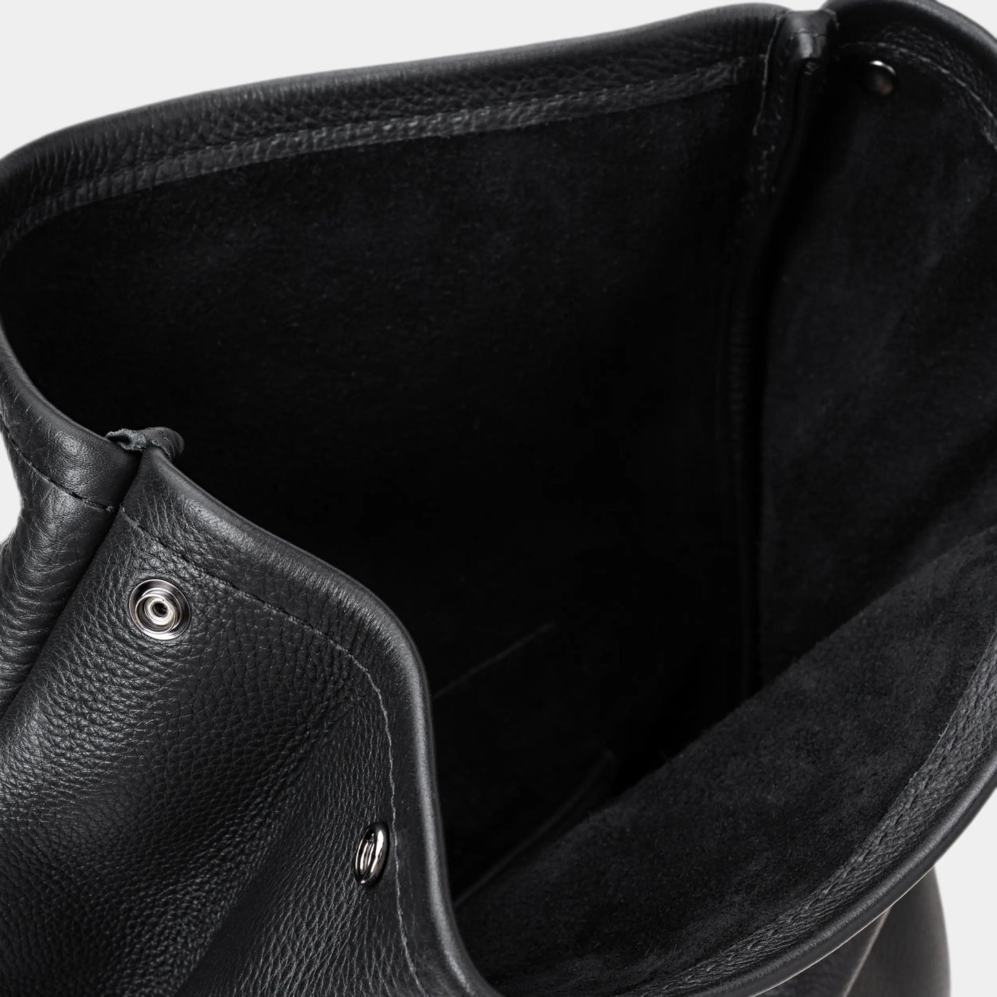 Close-up of coal Legacy leather backpack interior with suede lining