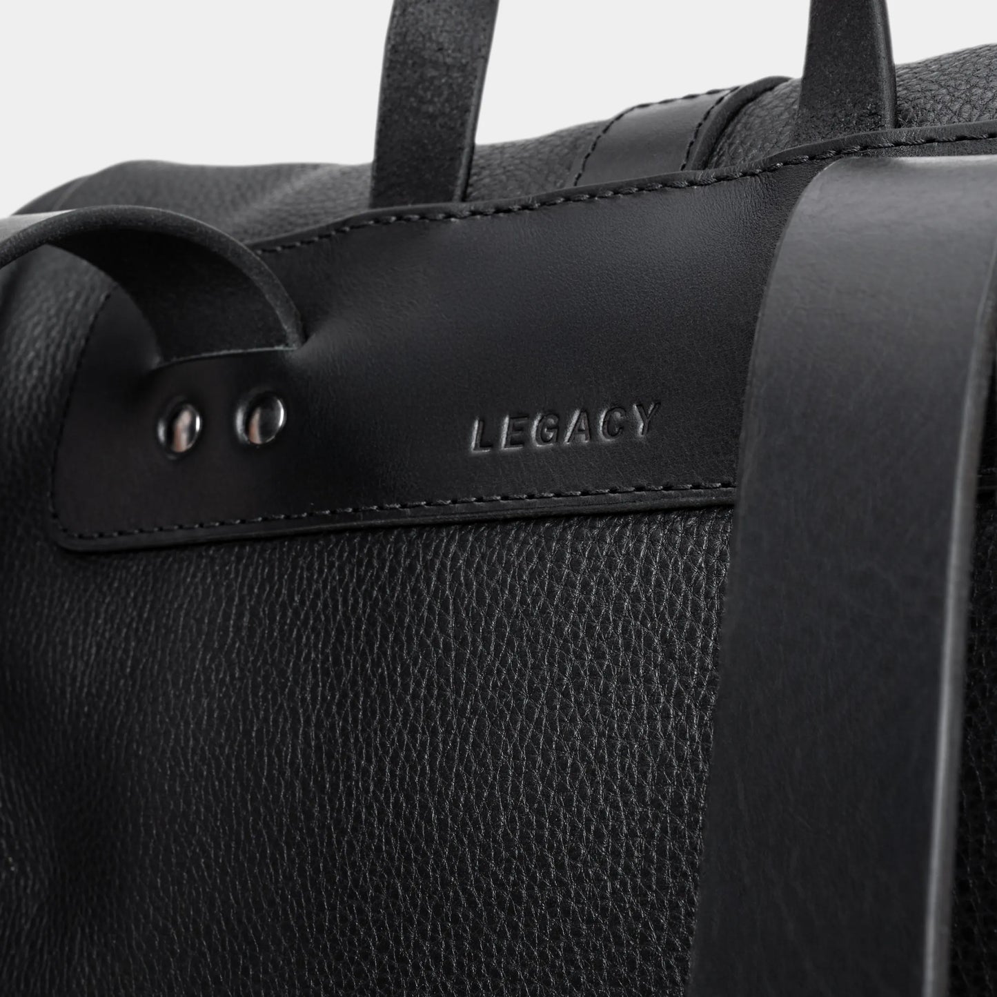 Close-up of the Legacy mark detail on the coal Nordweg leather backpack