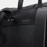 Close-up of the Legacy mark detail on the coal Nordweg leather backpack
