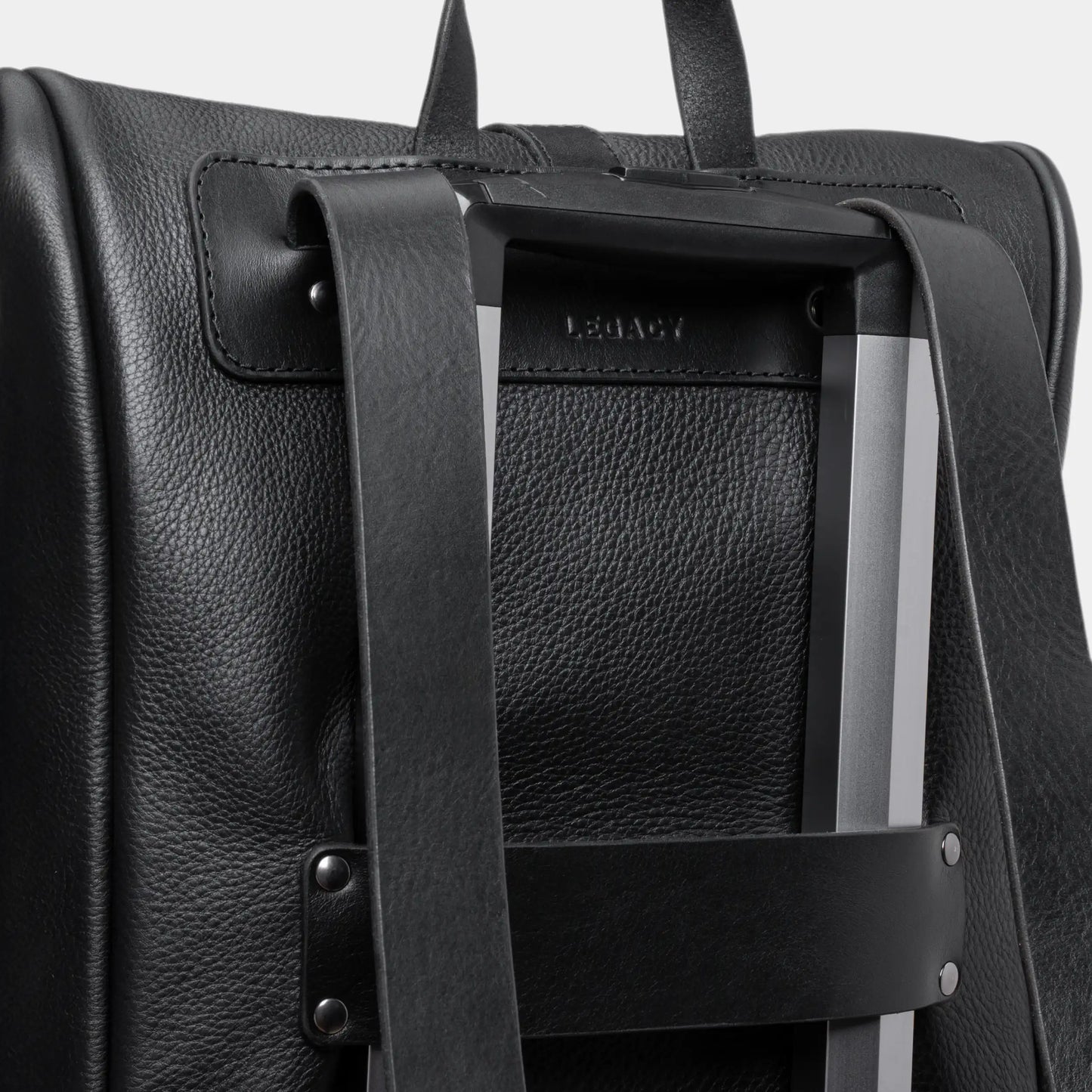 Coal Legacy leather backpack luggage pass-through on a rolling suitcase handle