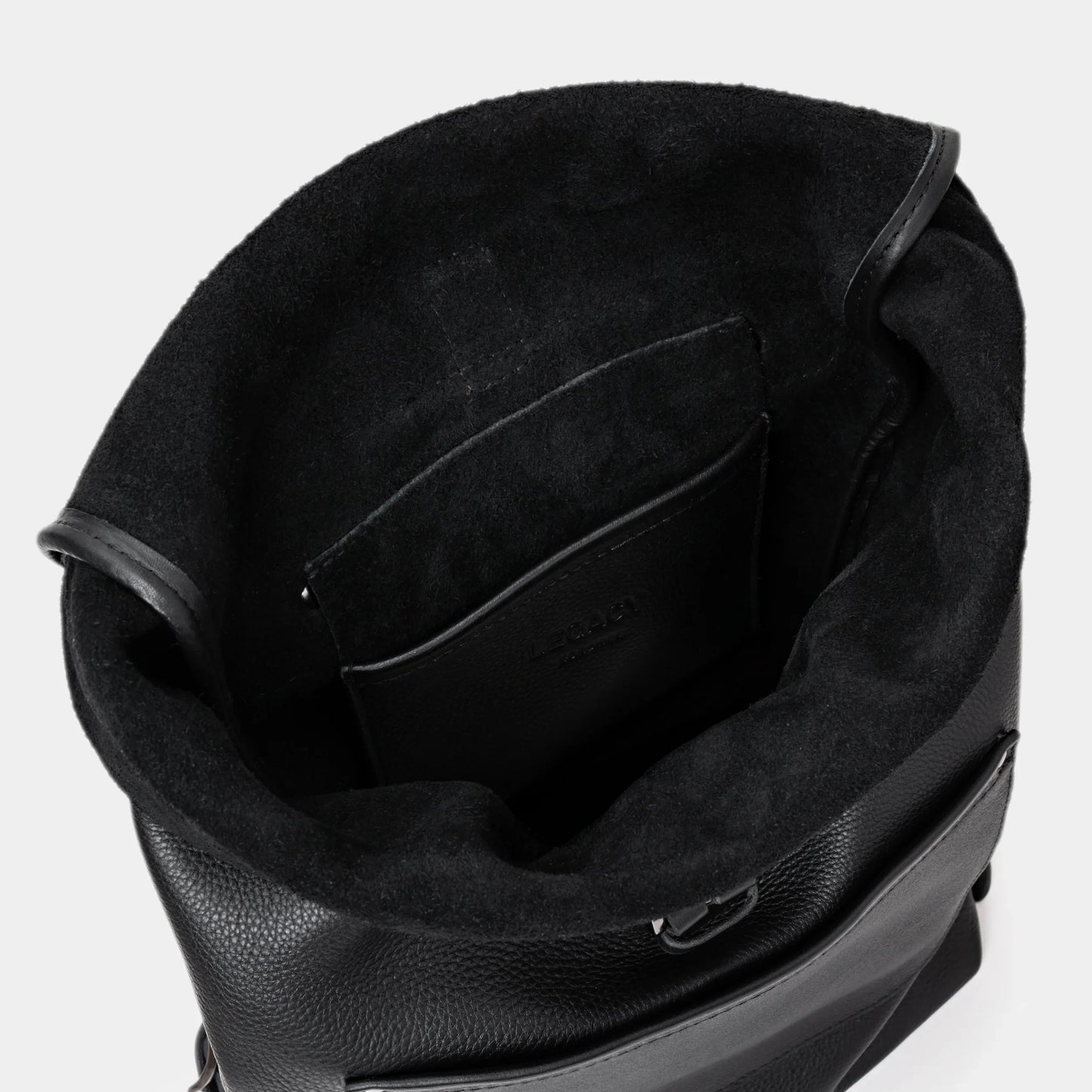 Open coal Legacy leather backpack showing top interior and leather pocket