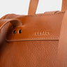 Close-up of the Legacy mark detail on the cognac Nordweg leather backpack