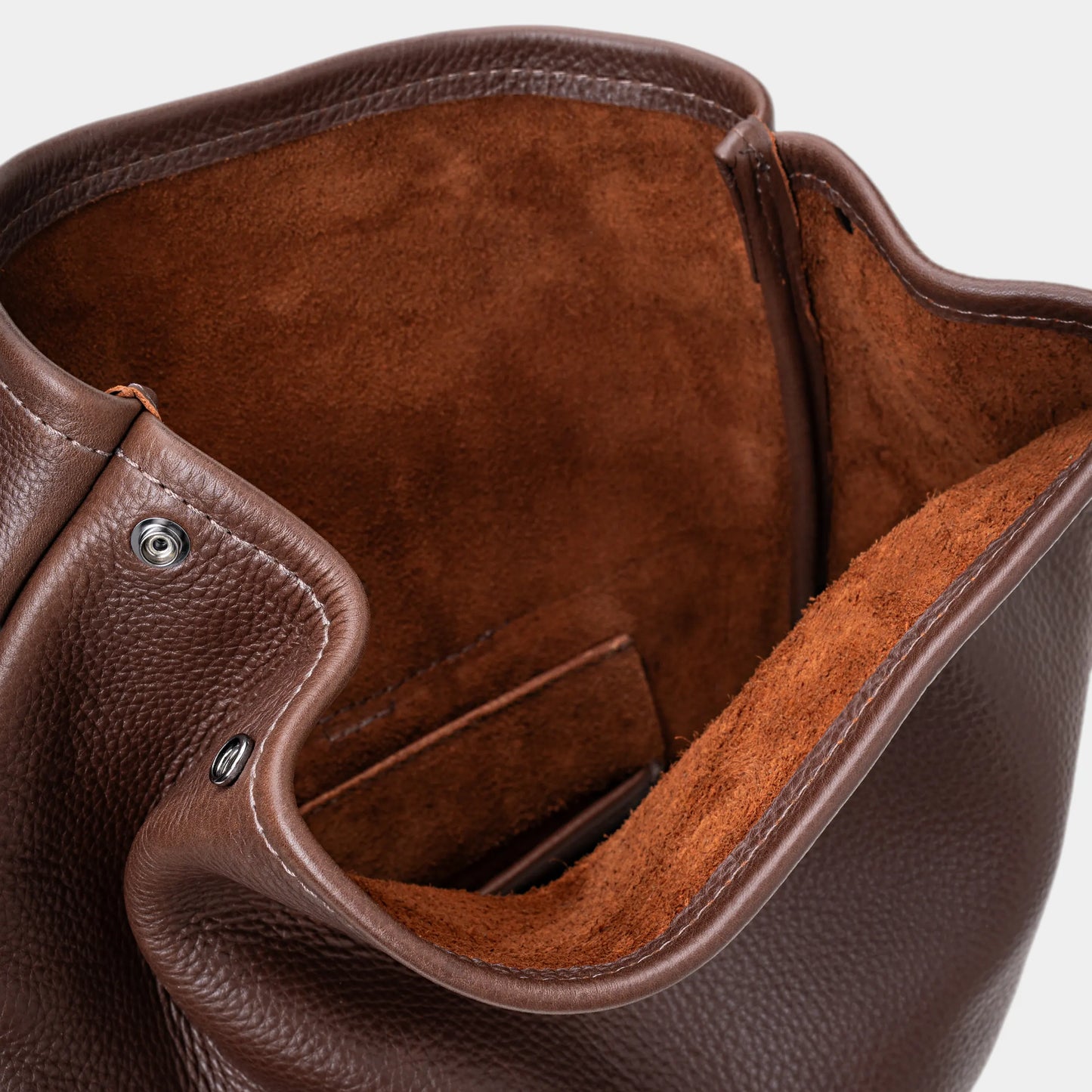 Close-up of espresso Legacy leather backpack interior with suede lining