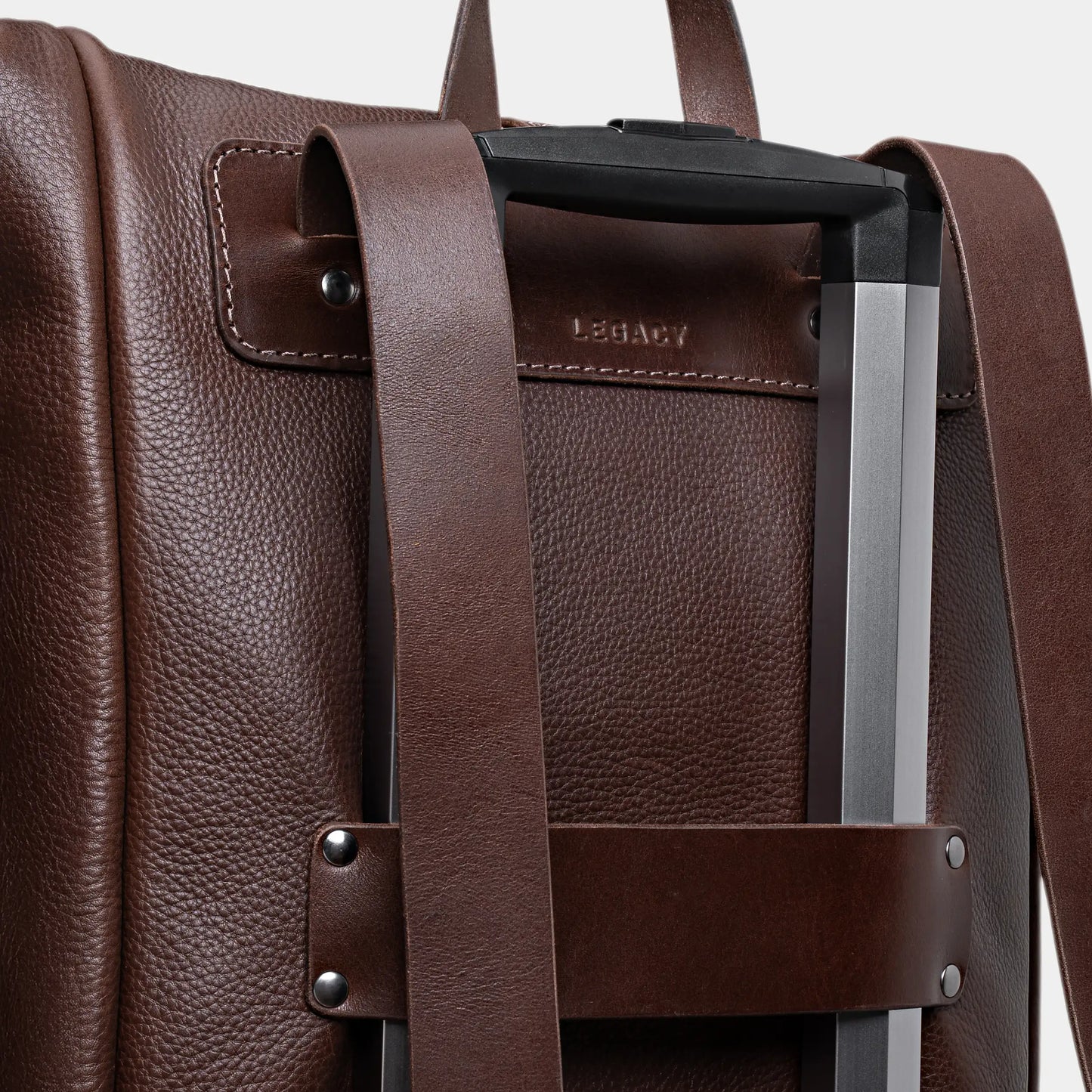 Espresso Legacy leather backpack luggage pass-through on a rolling suitcase handle