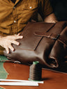 Nordweg artisan assembling an espresso Legacy leather backpack in the workshop, SKU NWL001.ES, GTIN 7898571002263