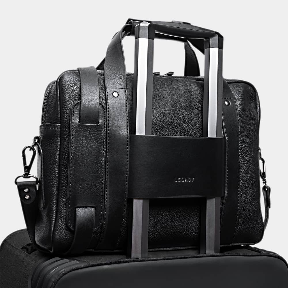 Coal Legacy leather briefcase luggage pass-through on a rolling suitcase handle