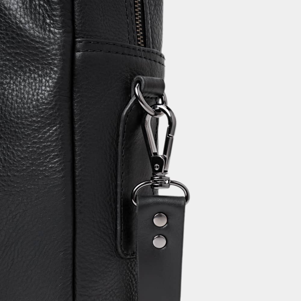 Close-up of coal Legacy leather briefcase shoulder strap hardware