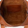 Open cognac Legacy leather briefcase showing interior pocket