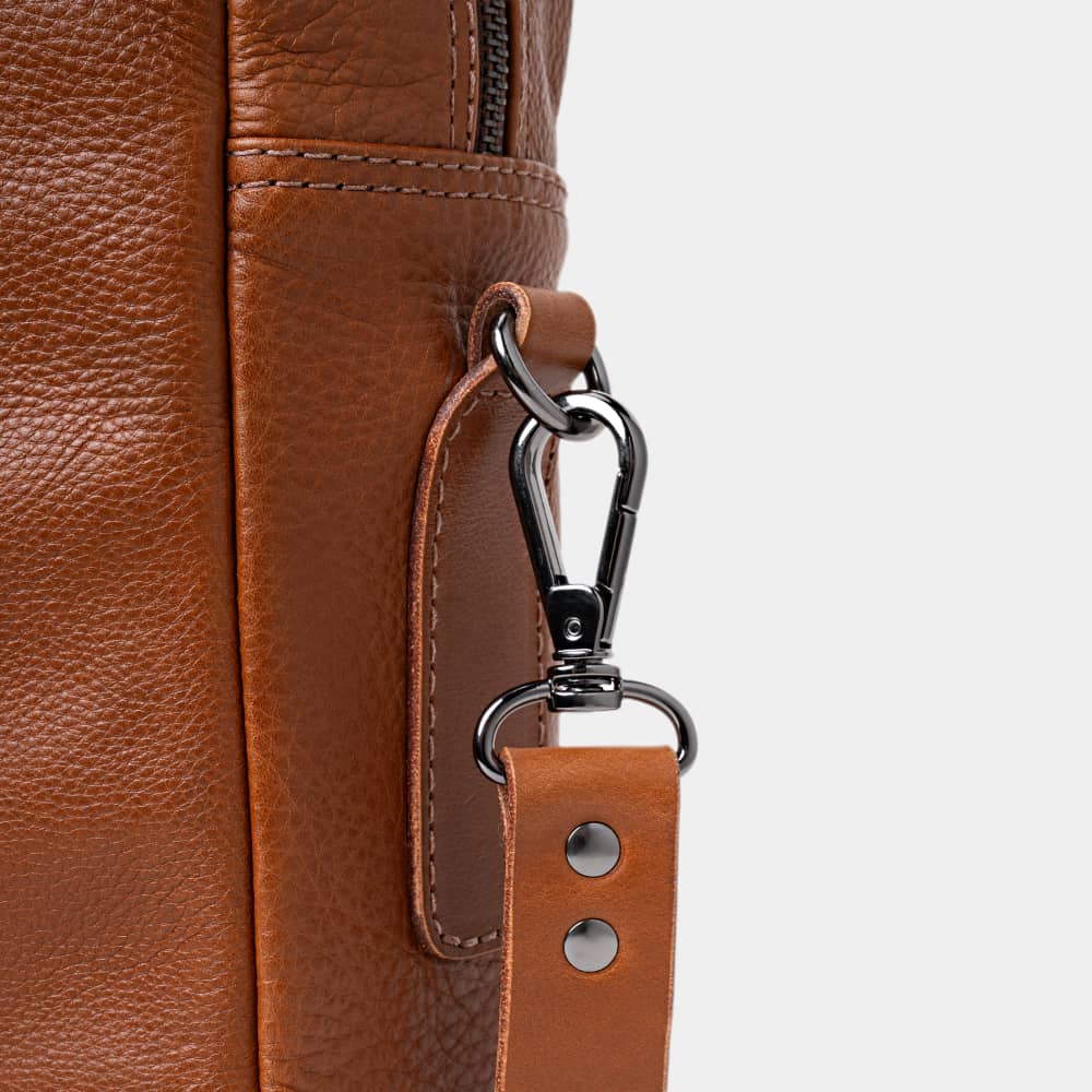 Close-up of cognac Legacy leather briefcase shoulder strap hardware