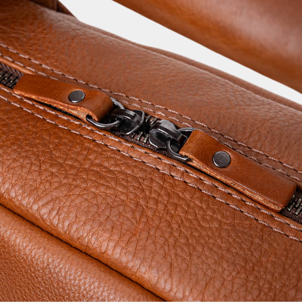 Close-up of cognac Legacy leather briefcase top zipper pulls