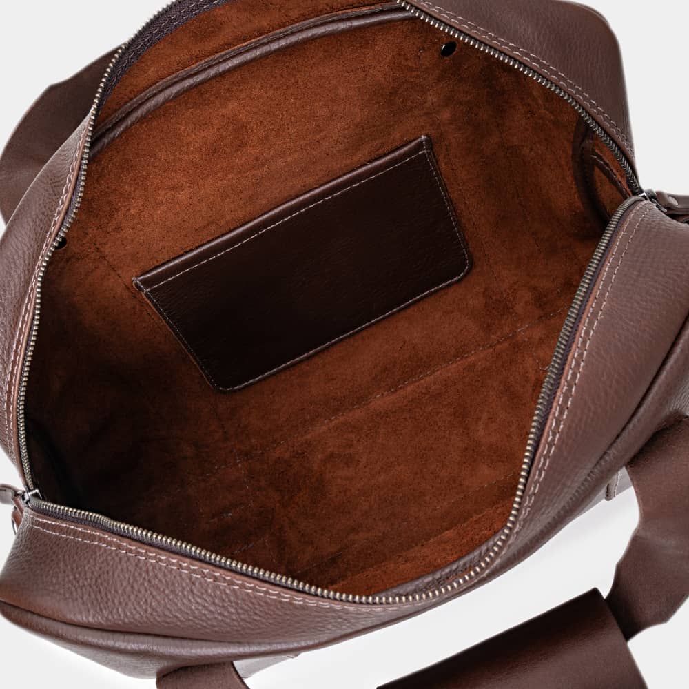 Open espresso Legacy leather briefcase showing interior pocket