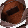 Open espresso Legacy leather briefcase showing interior pocket