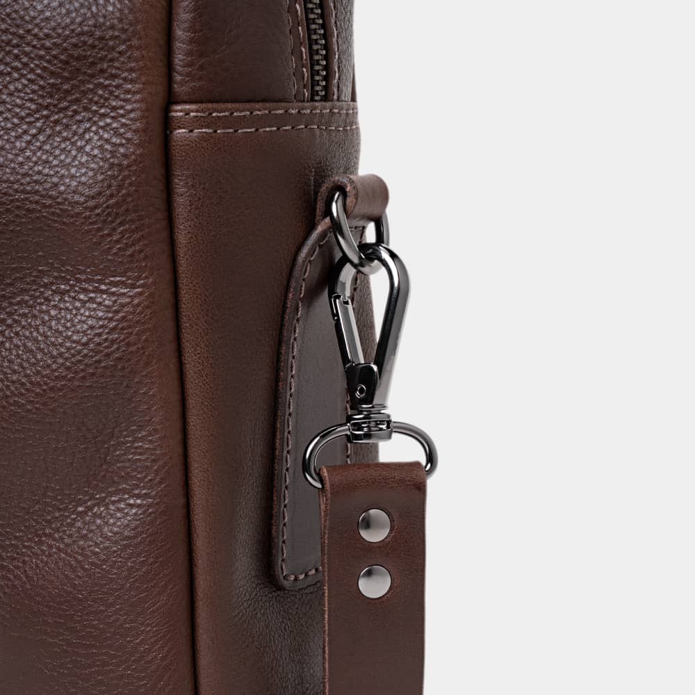 Close-up of espresso Legacy leather briefcase shoulder strap hardware
