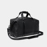 Nordweg Legacy leather duffel travel bag in coal, angled front view with shoulder strap