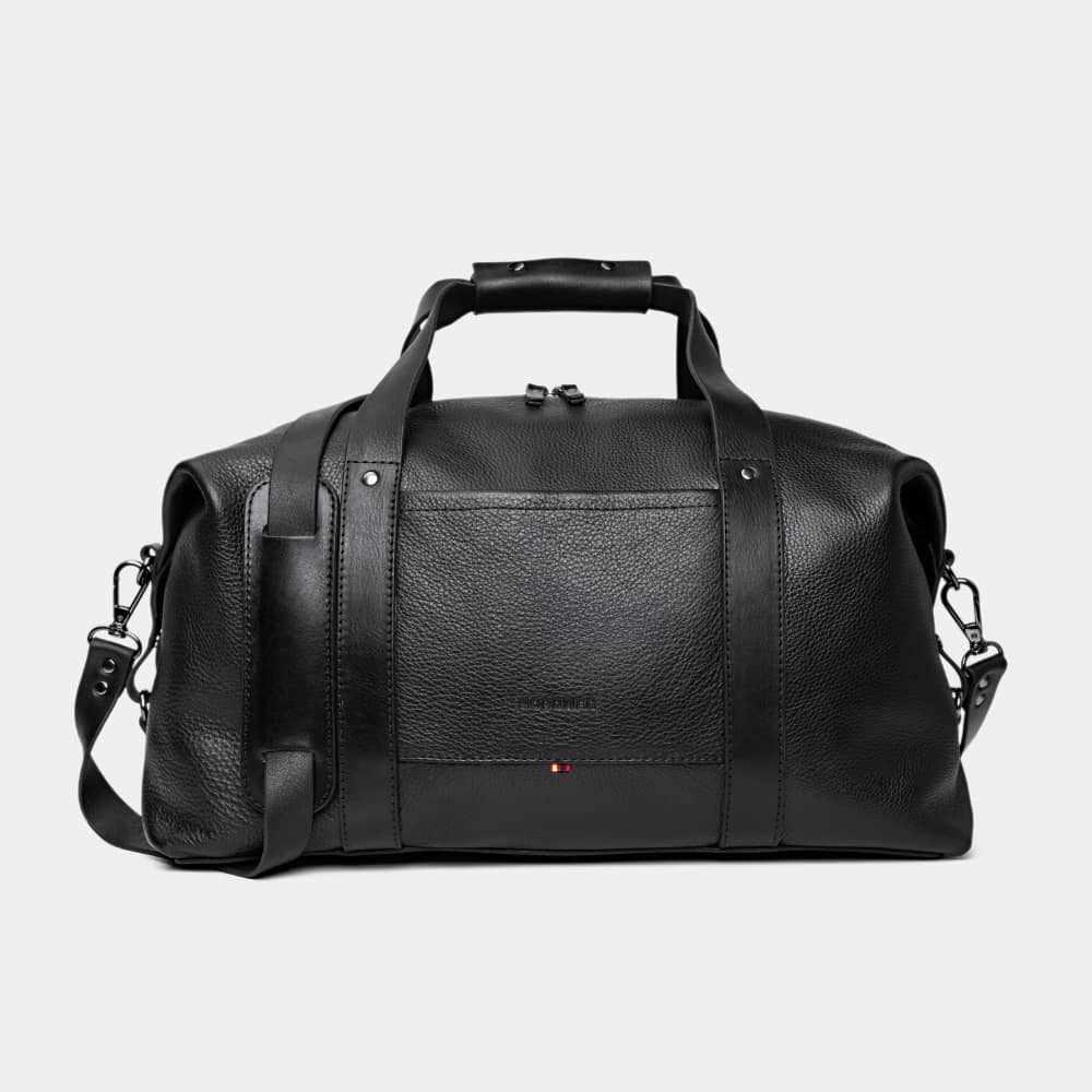 Nordweg Legacy leather duffel travel bag in coal, front view with handles and shoulder strap