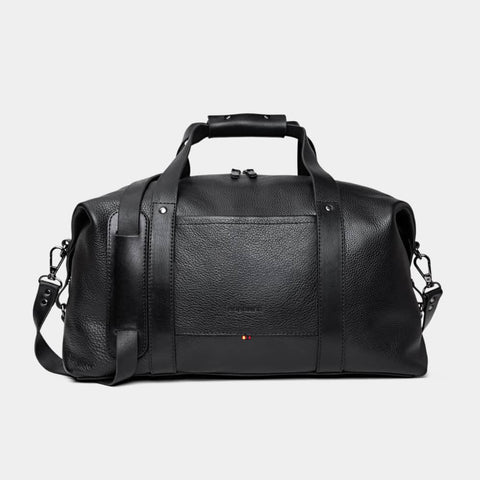 Nordweg Legacy leather duffel travel bag in coal, front view with handles and shoulder strap