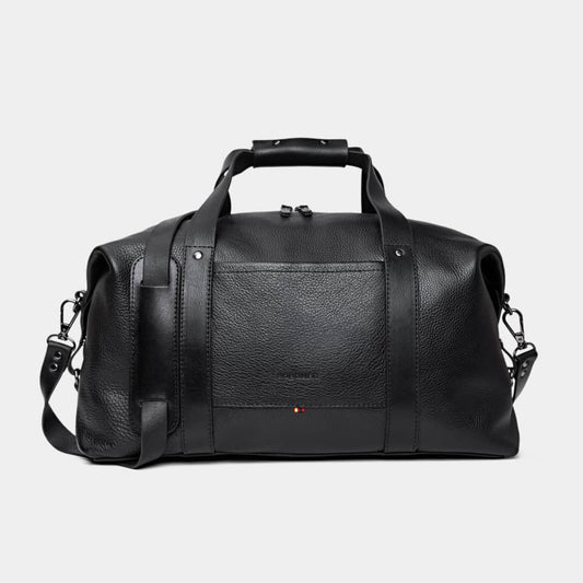 Nordweg Legacy leather duffel travel bag in coal, front view with handles and shoulder strap