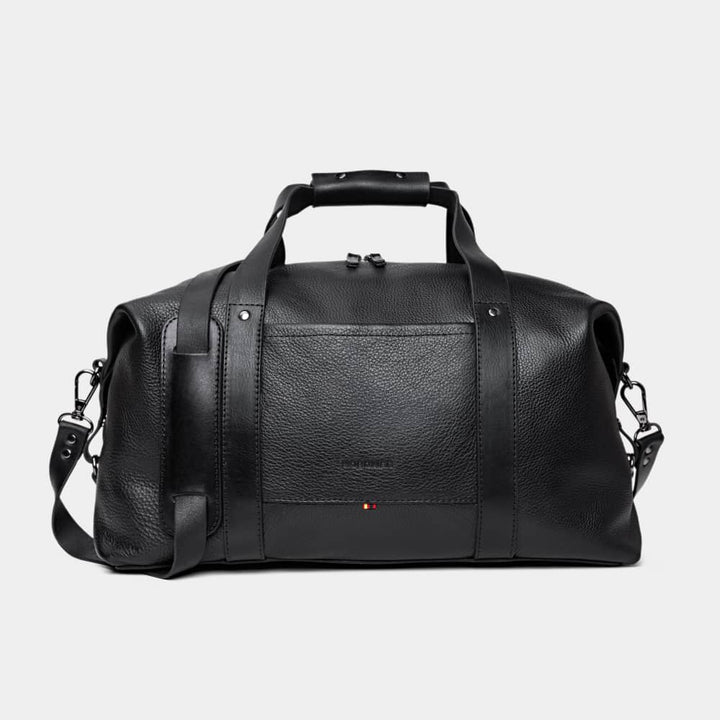 Nordweg Legacy leather duffel travel bag in coal, front view with handles and shoulder strap