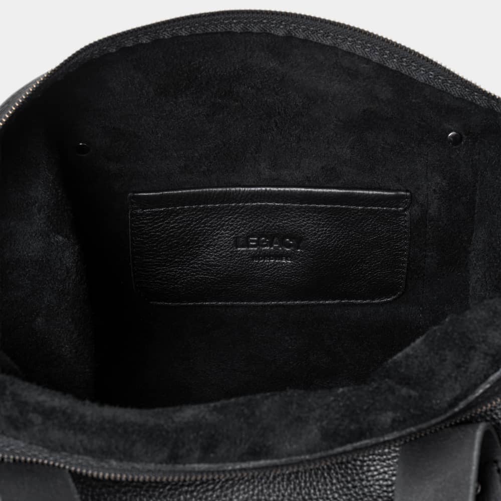 Open coal Legacy leather duffel bag showing interior pocket