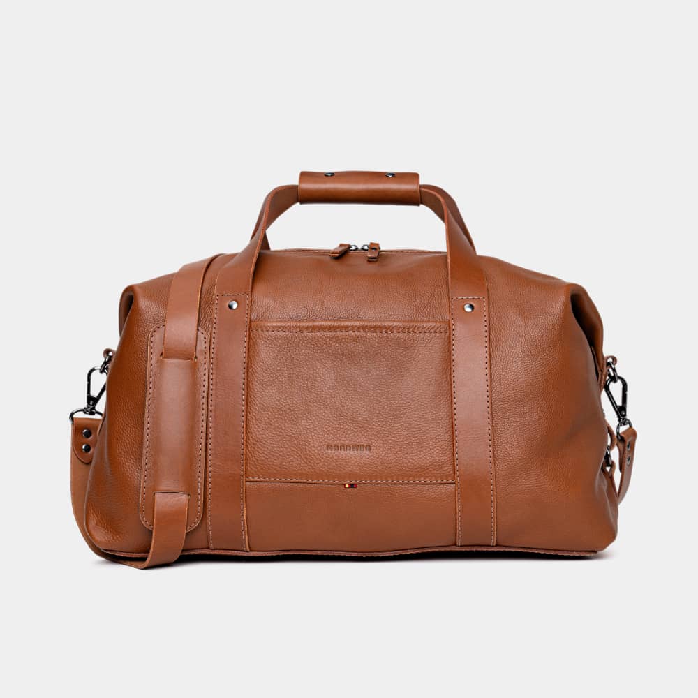 Nordweg Legacy leather duffel travel bag in cognac, front view with handles and shoulder strap