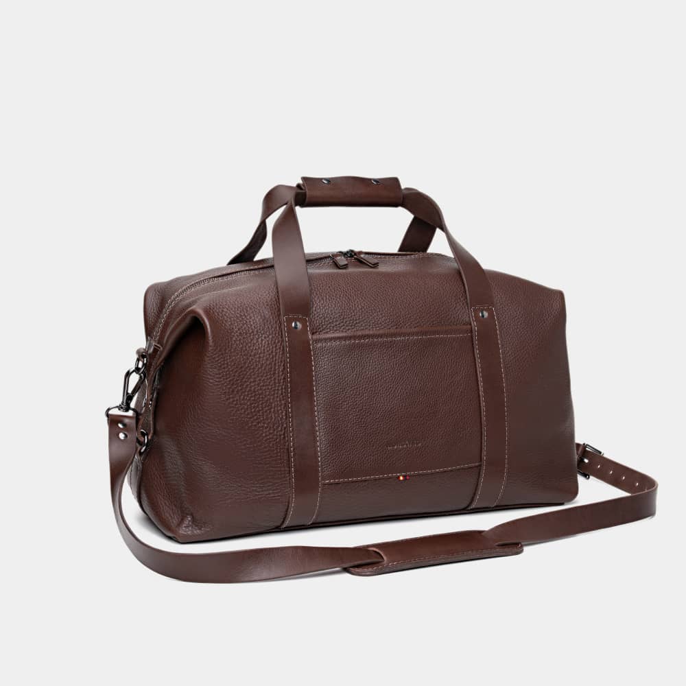 Nordweg Legacy leather duffel travel bag in espresso, angled front view with shoulder strap