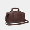 Nordweg Legacy leather duffel travel bag in espresso, angled front view with shoulder strap