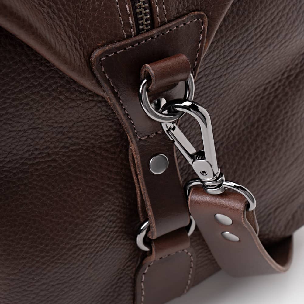Close-up of espresso Legacy leather duffel bag shoulder strap hardware