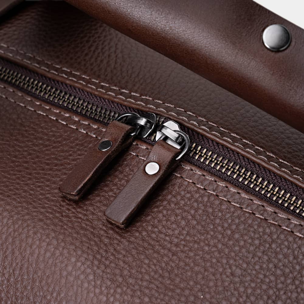 Close-up of espresso Legacy leather duffel bag top zipper pulls