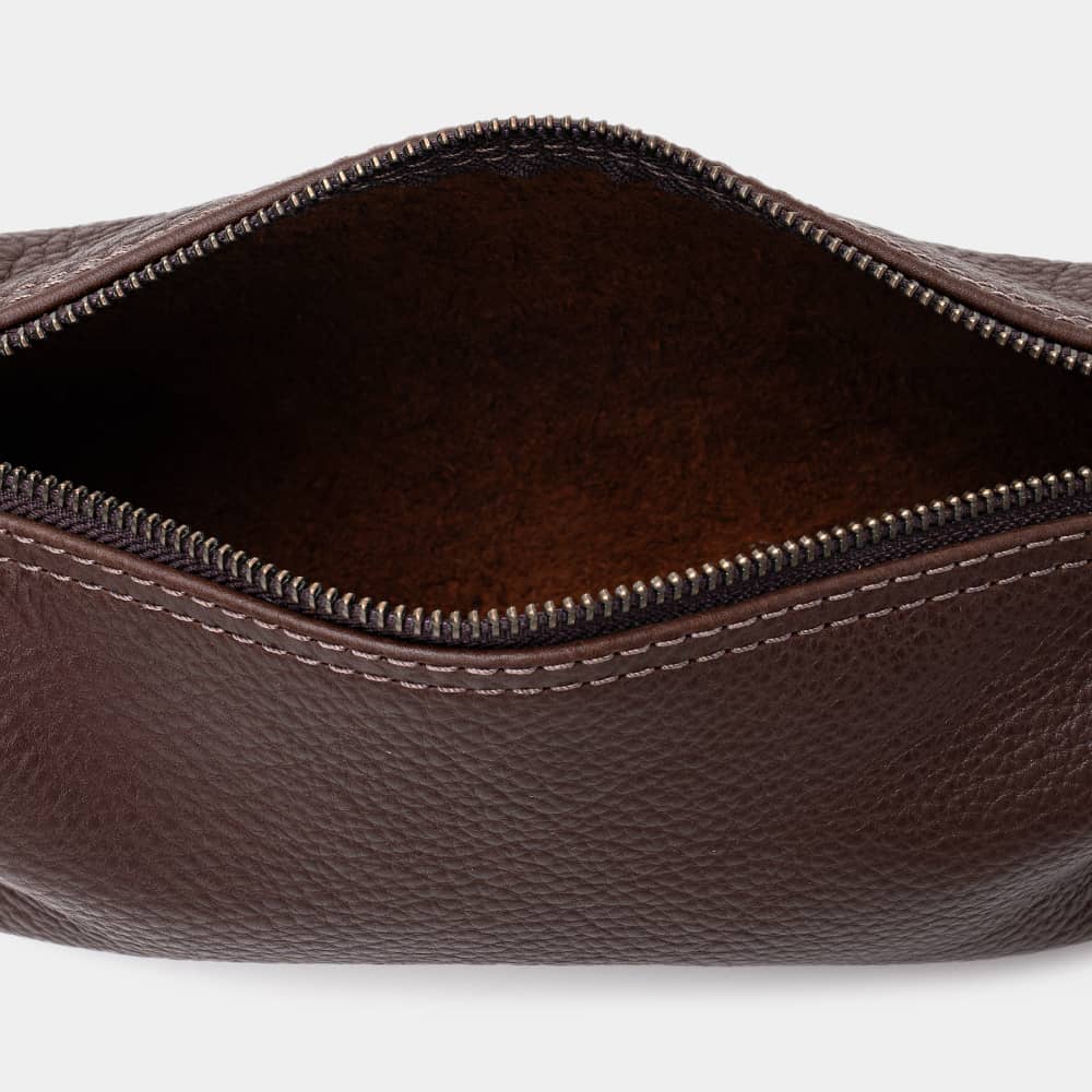 Open espresso Legacy leather organizer pouch showing suede interior and zipper