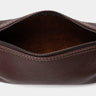 Open espresso Legacy leather organizer pouch showing suede interior and zipper