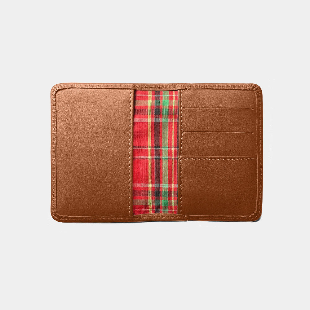 Open caramel Nordweg Marco leather AirTag wallet showing plaid interior and card slots